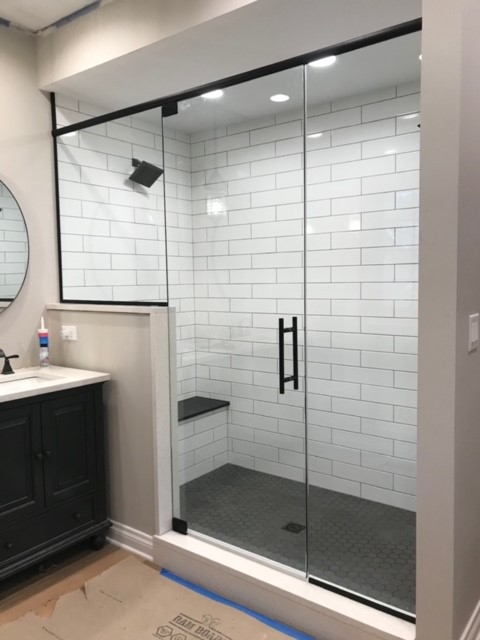 Shower Door With Header And Large Pivot Door 1 Panel Shorter Channel At Bottom Of Stationary Large Ladder Pull Clear Matte Black